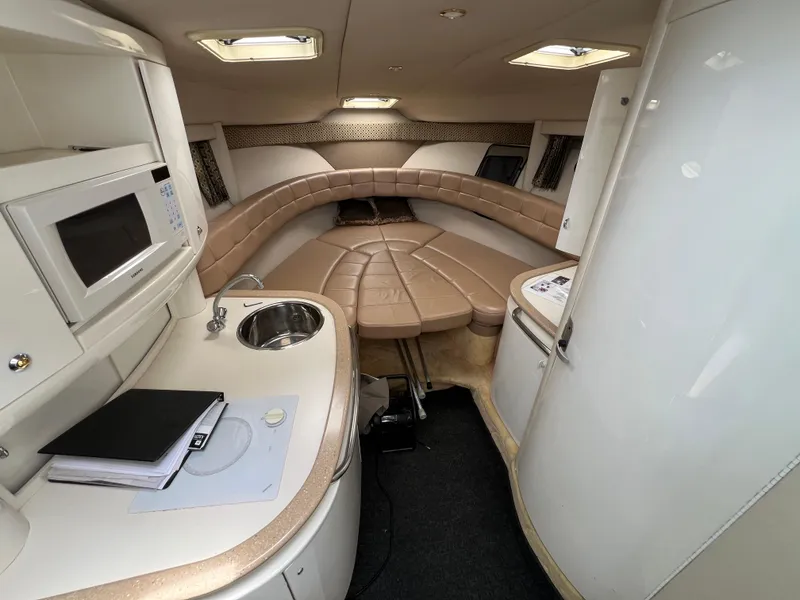 Slide: The Image of 2004 Formula 27 PC cabin interior with kitchenette, seating, and modern amenities. - 25