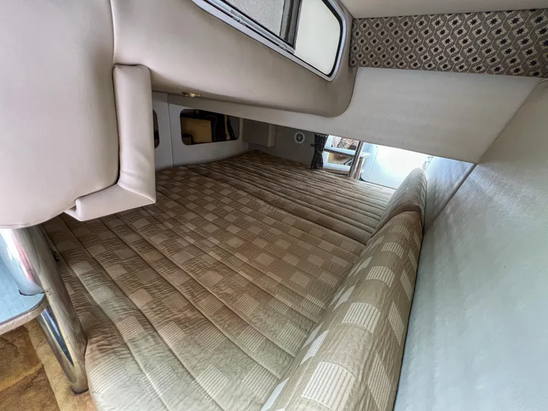 Slide: The Image of Interior cabin of 2004 Formula 27 PC boat with beige upholstery and patterned cushions. - 28