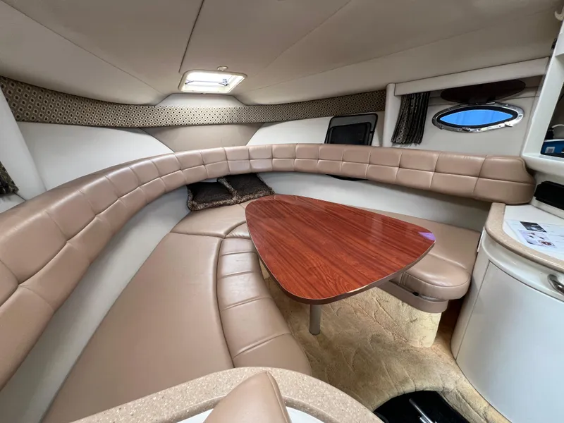 Slide: The Image of 2004 Formula 27 PC cabin interior with beige seating and wooden table. - 29