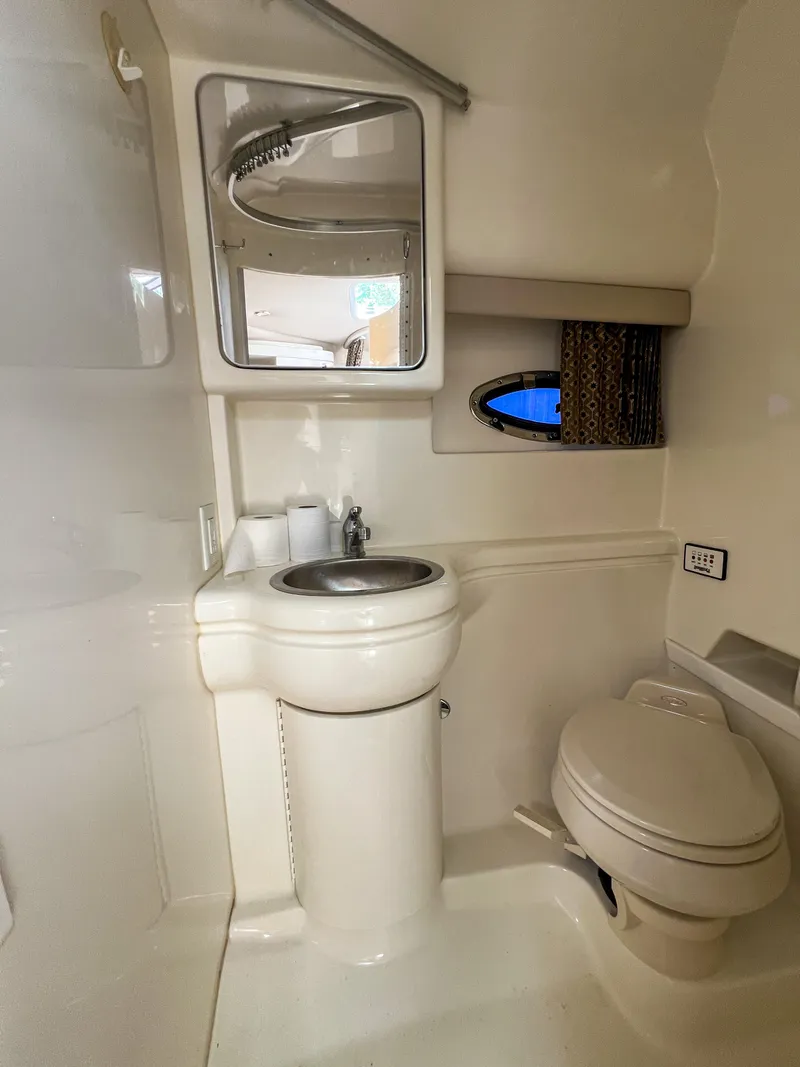 Slide: The Image of 2004 Formula 27 PC boat bathroom with sink, mirror, and toilet. - 33