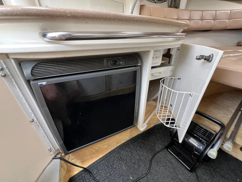 Slide: The Image of 2004 Formula 27 PC interior with mini fridge and storage compartment. - 35