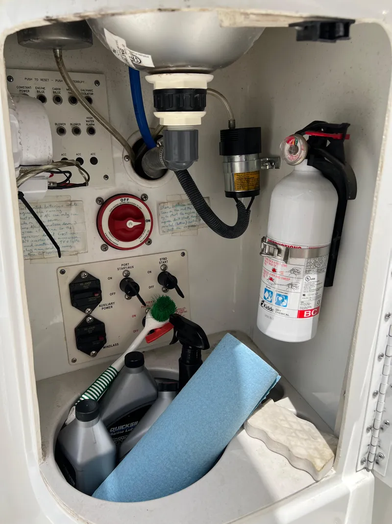 Slide: The Image of 2004 Formula 27 PC boat interior with fire extinguisher, control panel, and cleaning supplies. - 38