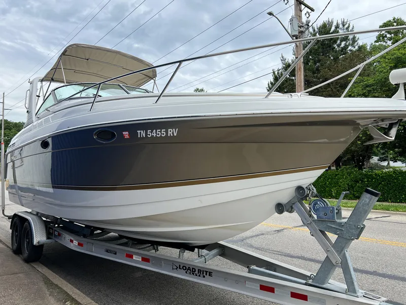 Slide: The Image of 2004 Formula 27 PC boat on trailer, parked on street, overcast sky. - 4