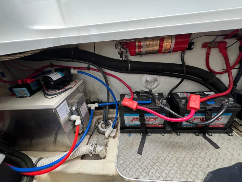 Slide: The Image of Engine compartment of a 2004 Formula 27 PC boat with batteries and wiring. - 43