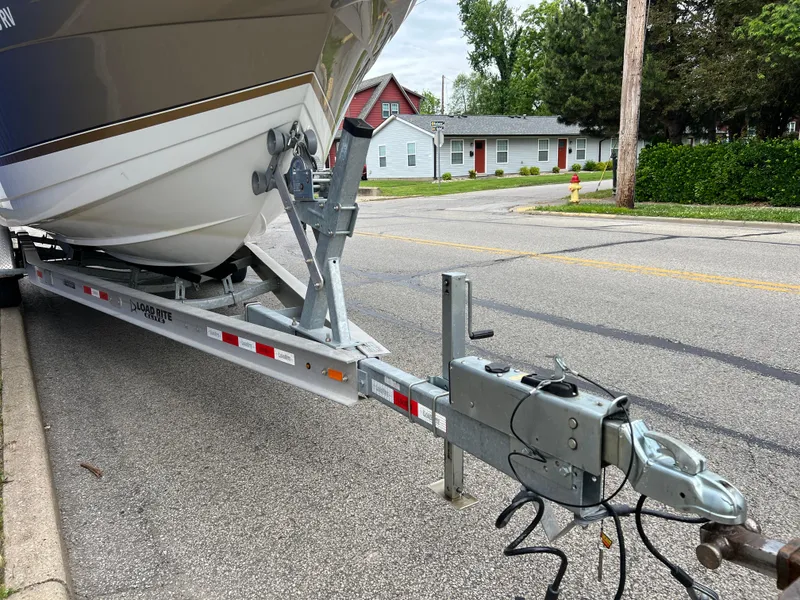 Slide: The Image of 2004 Formula 27 PC boat on trailer parked on street near residential area. - 44