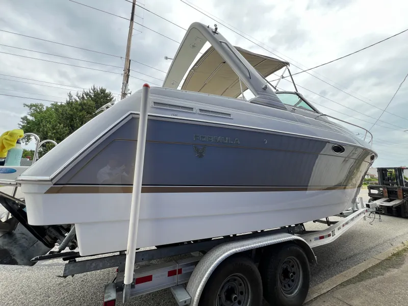 Slide: The Image of 2004 Formula 27 PC boat on trailer, side view, overcast sky. - 6