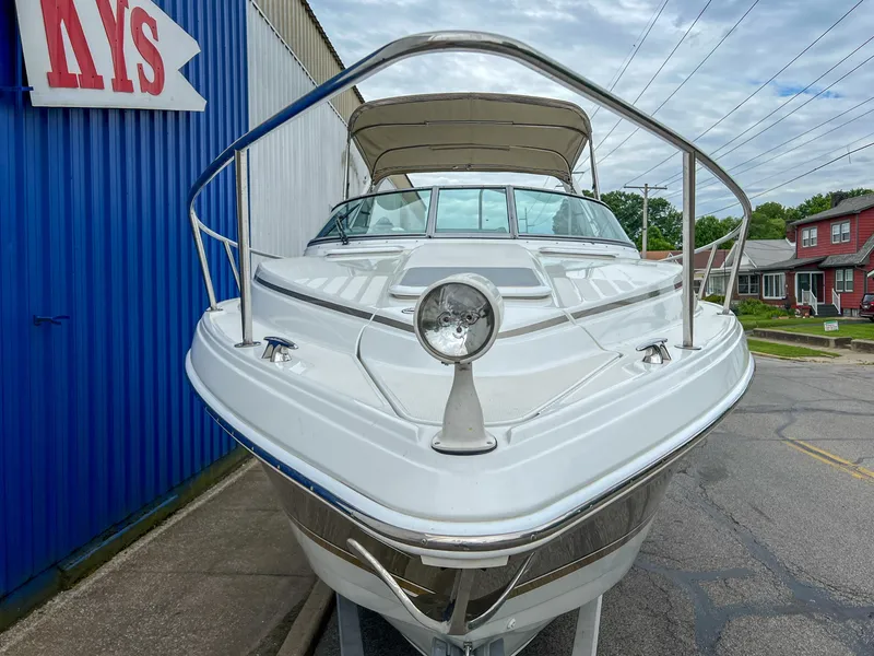 Slide: The Image of 2004 Formula 27 PC boat docked near blue building, front view. - 8