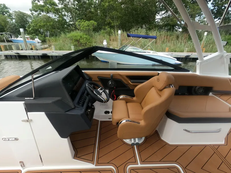 Slide: The Image of Interior of 2026 Cobalt R6 boat with tan leather seating and modern dashboard. - 13