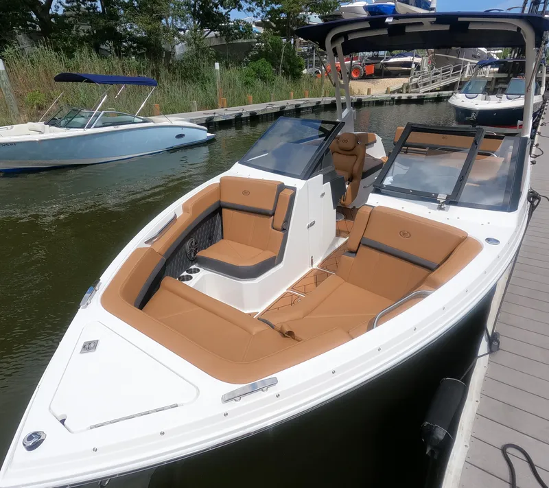 Slide: The Image of 2026 Cobalt R6 boat with tan seating, docked at a marina. - 21