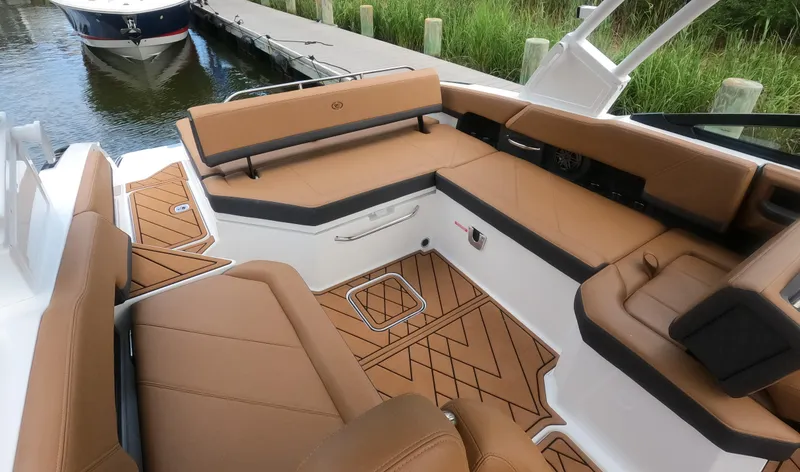 Slide: The Image of 2026 Cobalt R6 boat interior with tan seating and geometric flooring design. - 6