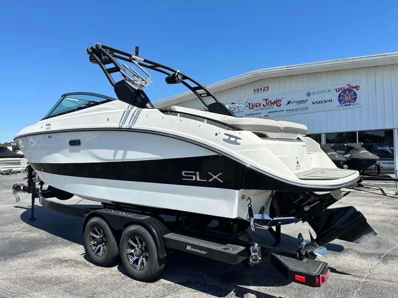 Slide: The Image of 2023 Sea Ray 260 SLX boat on trailer, sleek design, black and white color scheme. - 3