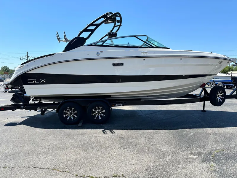 Slide: The Image of 2023 Sea Ray 260 SLX boat on trailer, sleek design, black and white color scheme. - 4
