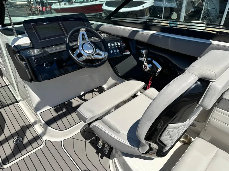 Slide: The Image of 2023 Sea Ray 260 SLX boat dashboard with dual Simrad displays and modern steering wheel. - 9