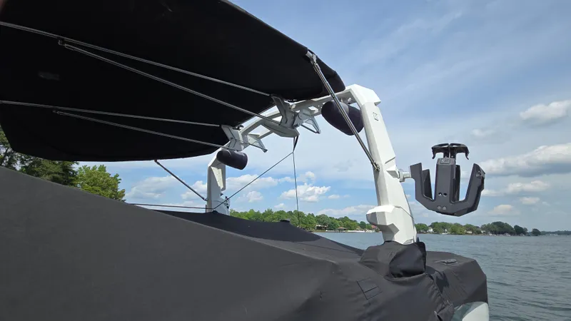 Slide: The Image of 2022 Correct Craft Super Air Nautique G23 boat with canopy on a lake. - 15