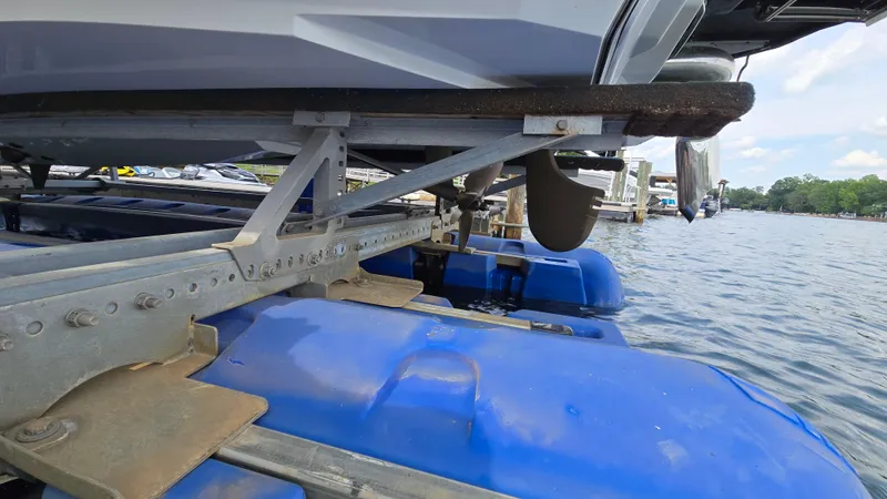 Slide: The Image of 2022 Correct Craft Super Air Nautique G23 on blue floating dock by the water. - 16