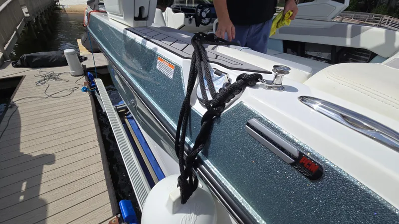 Slide: The Image of 2022 Correct Craft Super Air Nautique G23 boat docked with fender and rope. - 17