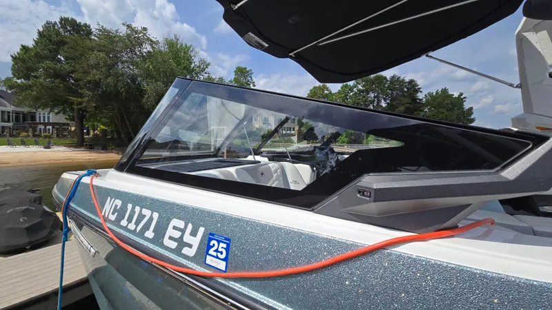 Slide: The Image of 2022 Correct Craft Super Air Nautique G23 boat docked, featuring sleek design and modern details. - 18