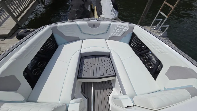 Slide: The Image of 2022 Correct Craft Super Air Nautique G23 boat interior with luxurious seating and modern design. - 25