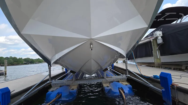 Slide: The Image of 2022 Correct Craft Super Air Nautique G23 boat on lift at marina dock. - 3