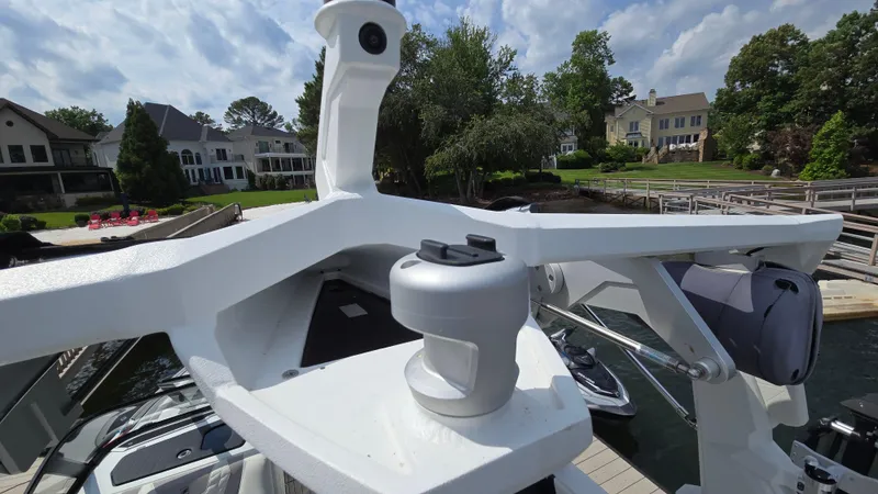 Slide: The Image of 2022 Correct Craft Super Air Nautique G23 boat docked near waterfront homes. - 34