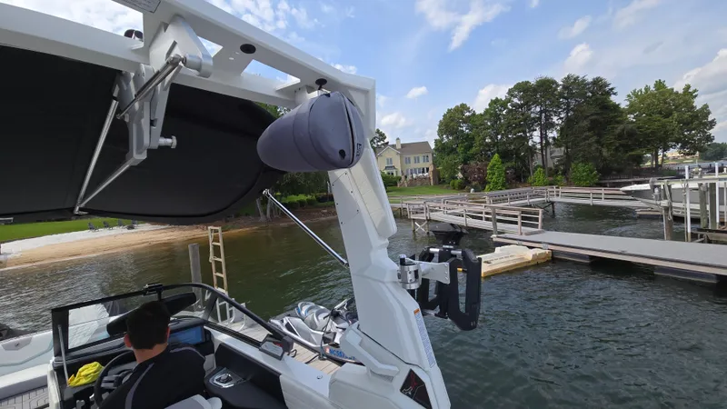 Slide: The Image of 2022 Correct Craft Super Air Nautique G23 boat docked by a lakeside with scenic view. - 36