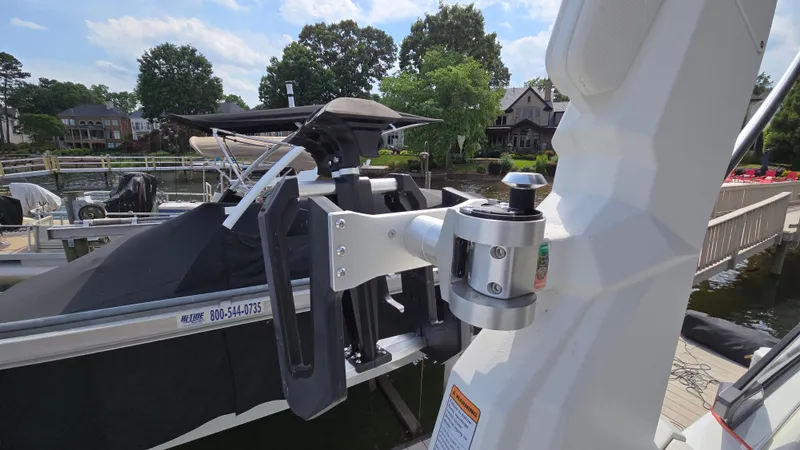 Slide: The Image of 2022 Correct Craft Super Air Nautique G23 boat detail, docked with visible wakeboard rack. - 37