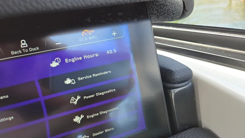 Slide: The Image of 2022 Correct Craft Super Air Nautique G23 dashboard displaying engine hours and diagnostics menu. - 44