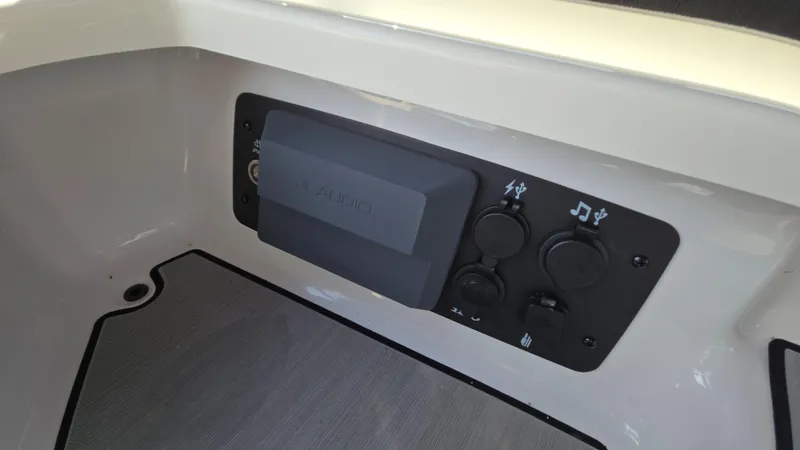 Slide: The Image of Control panel of 2022 Correct Craft Super Air Nautique G23 boat, featuring audio controls. - 47