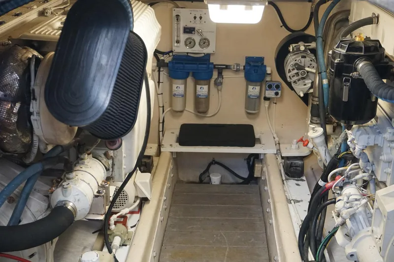Slide: The Image of Engine room of 2005 Mirage Yachts 40 Convertible, showcasing mechanical components and filtration systems. - 15