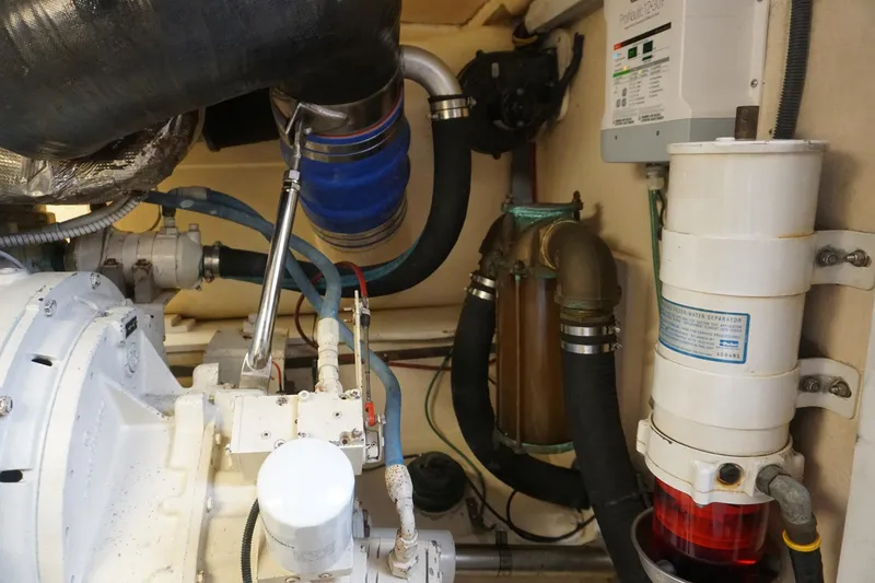 Slide: The Image of Engine room of 2005 Mirage Yachts 40 Convertible, showcasing mechanical components and systems. - 18
