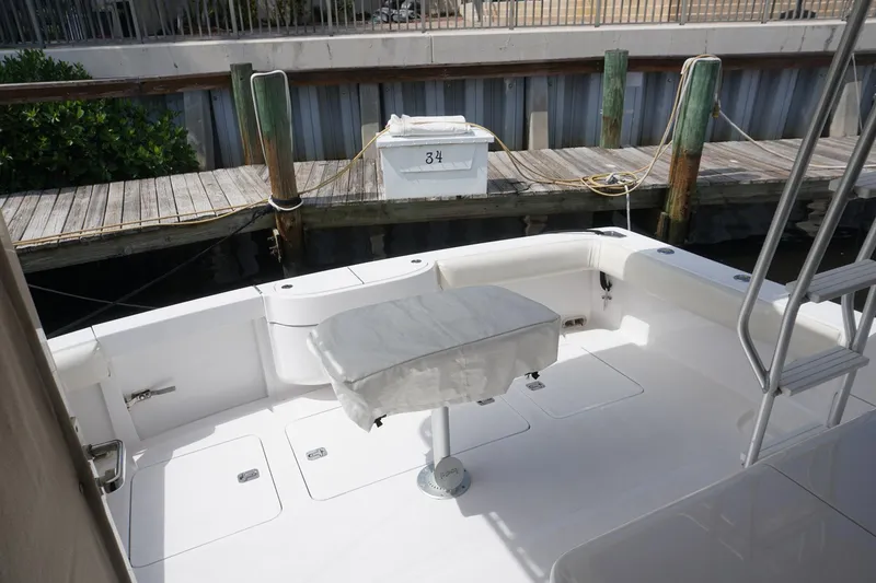 Slide: The Image of 2005 Mirage Yachts 40 Convertible, spacious deck area with seating, docked at marina. - 19