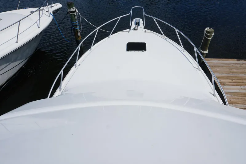 Slide: The Image of 2005 Mirage Yachts 40 Convertible boat docked, aerial view of bow and deck. - 25