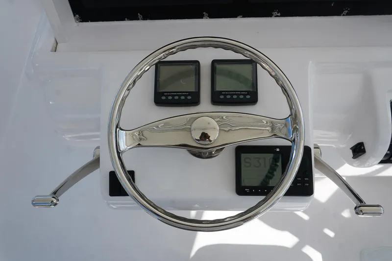 Slide: The Image of Steering wheel and controls of 2005 Mirage Yachts 40 Convertible boat. - 27