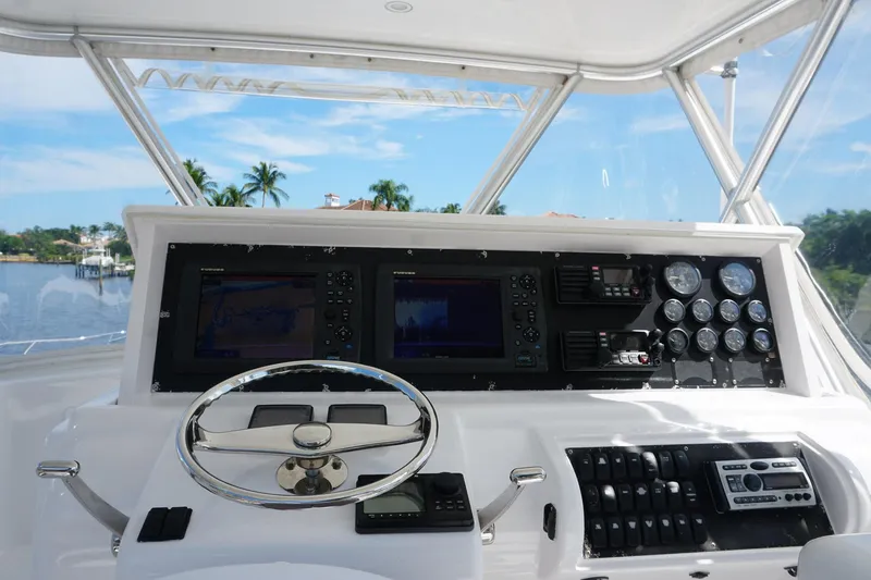 Slide: The Image of Helm of 2005 Mirage Yachts 40 Convertible with navigation instruments and steering wheel. - 28