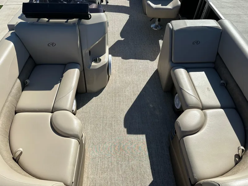 Slide: The Image of 2020 Avalon LSZ 2485 QL pontoon boat interior with beige seating and carpet flooring. - 4