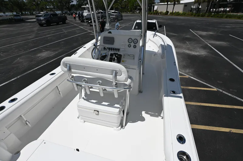 Slide: The Image of 2013 Sea Fox 226 Commander boat interior with helm and seating in a parking lot. - 10