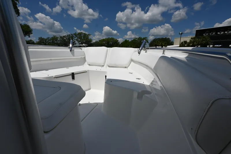 Slide: The Image of 2013 Sea Fox 226 Commander boat interior with white seating under a blue sky. - 12