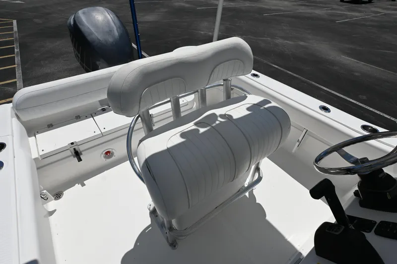 Slide: The Image of 2013 Sea Fox 226 Commander boat interior with white seating and steering wheel. - 14
