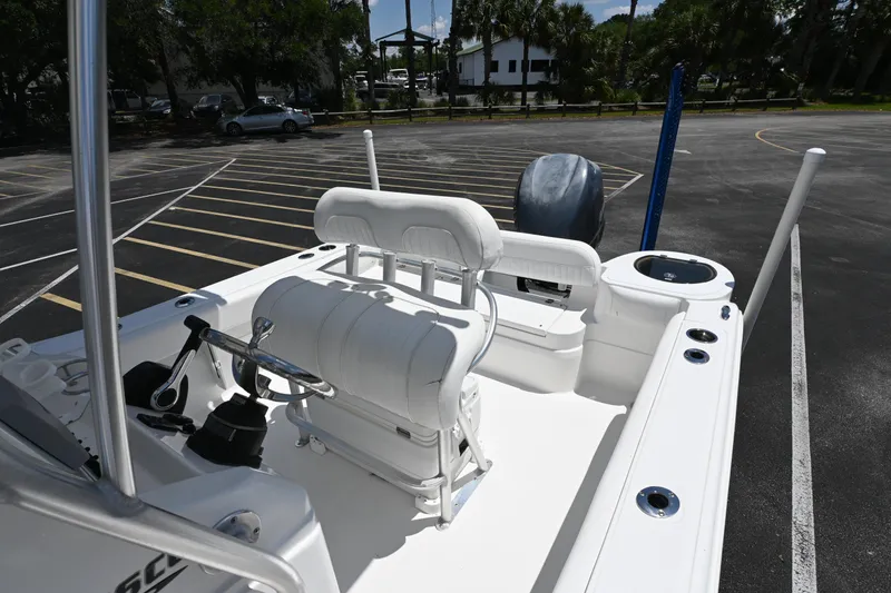 Slide: The Image of 2013 Sea Fox 226 Commander boat interior with seating and console in a parking lot. - 19