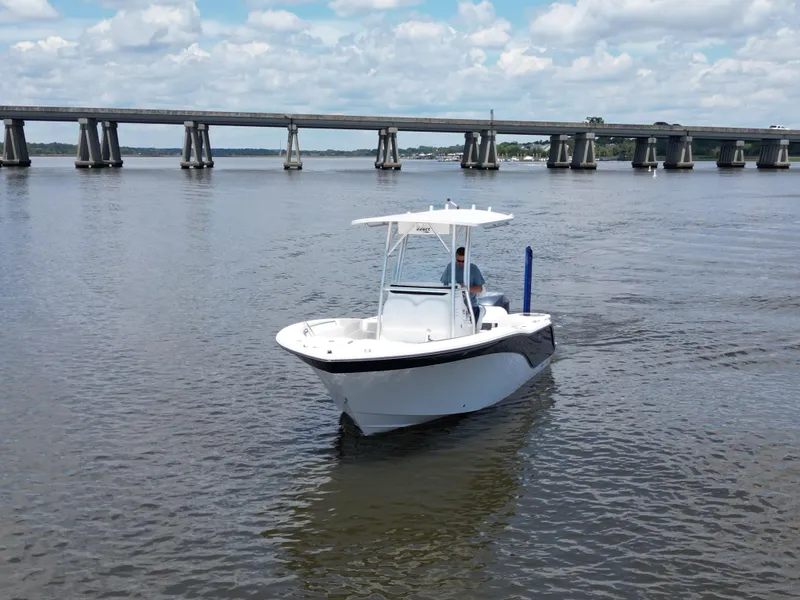 Slide: The Image of 2013 Sea Fox 226 Commander boat on calm water near a bridge under a cloudy sky. - 3