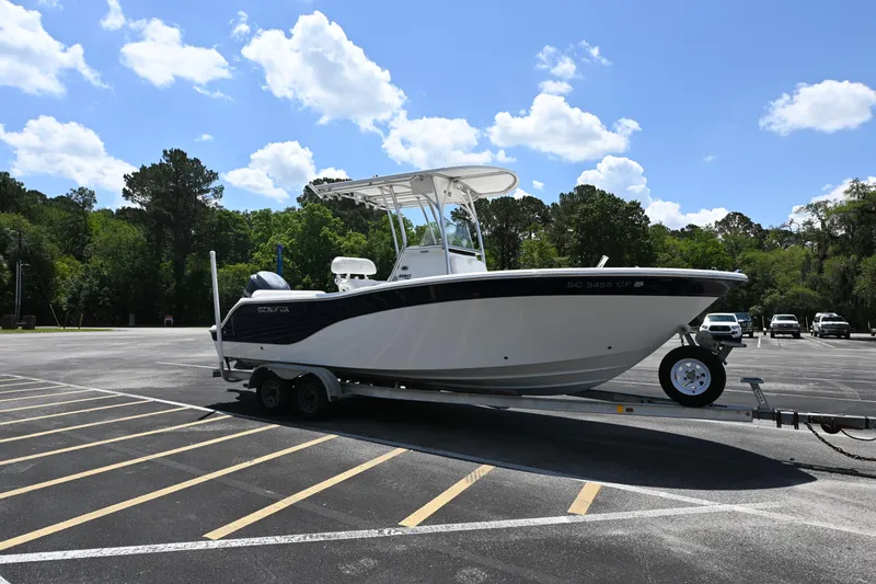 Slide: The Image of 2013 Sea Fox 226 Commander boat on trailer in parking lot under blue sky. - 5