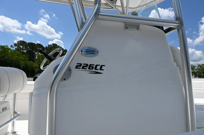 Slide: The Image of 2013 Sea Fox 226 Commander boat console with steering wheel, under a clear blue sky. - 8