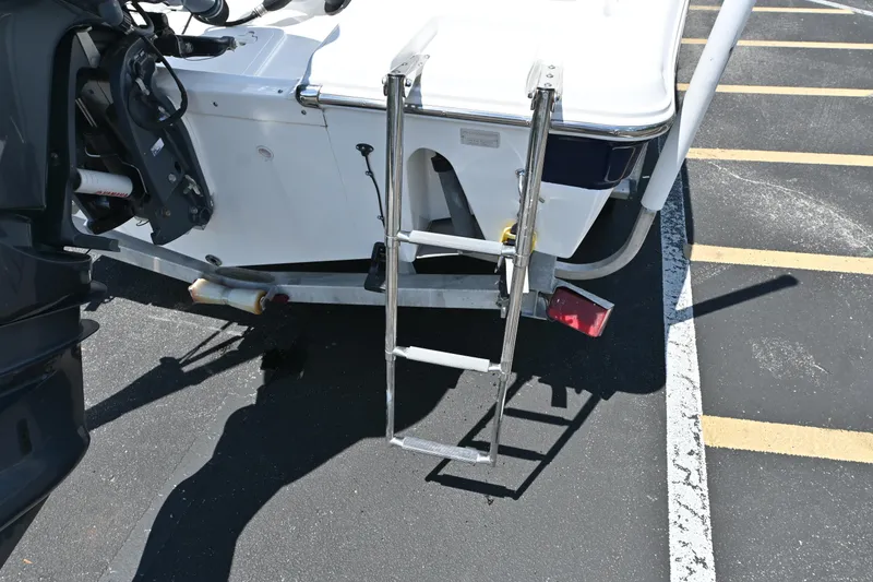Slide: The Image of 2013 Sea Fox 226 Commander boat with ladder on trailer in parking lot. - 9