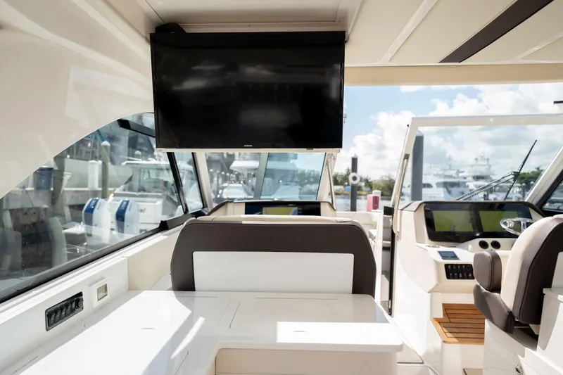 Slide: The Image of Interior of 2022 Regal 36 LX yacht with modern seating and navigation equipment. - 22