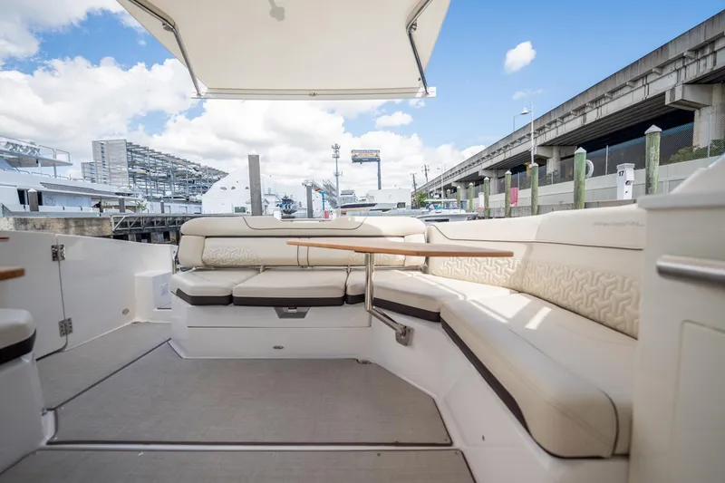 Slide: The Image of Luxurious seating area on 2022 Regal 36 LX boat, featuring elegant design and spacious comfort. - 26