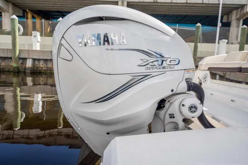 Slide: The Image of Yamaha XTO Offshore engine on 2022 Regal 36 LX boat, docked by the water. - 29