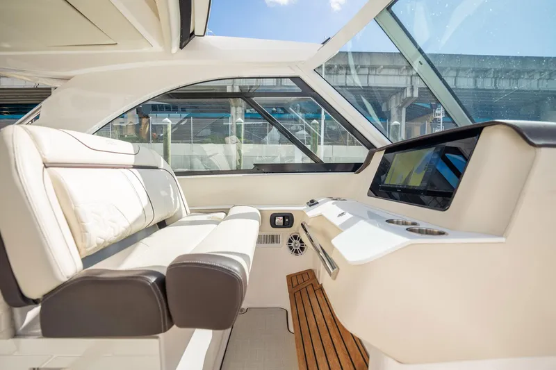 Slide: The Image of Interior of 2022 Regal 36 LX boat with luxurious seating and modern dashboard. - 8