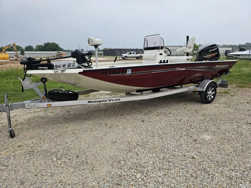 Slide: The Image of 2020 Ranger RB 190 boat on trailer, parked on gravel, with visible outboard motor. - 1