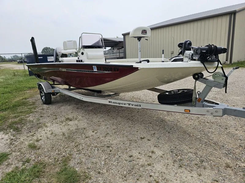 Slide: The Image of 2020 Ranger RB 190 boat on trailer, parked outdoors near a building. - 11
