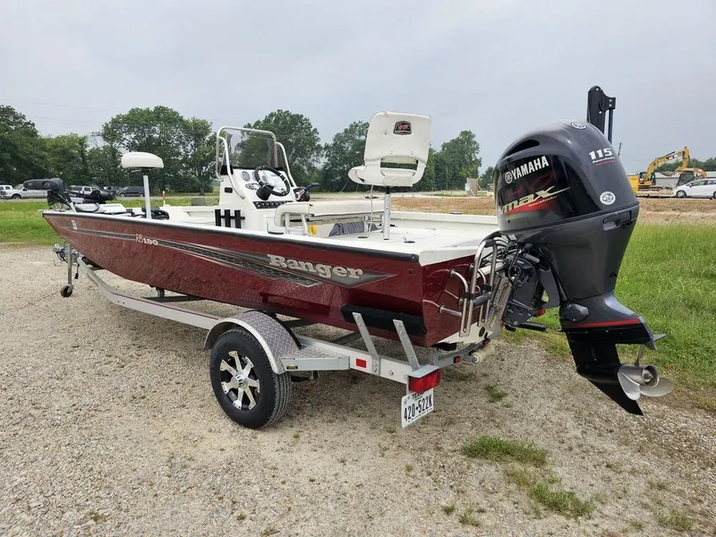 Slide: The Image of 2020 Ranger RB 190 boat with Yamaha motor on a trailer, parked outdoors. - 2